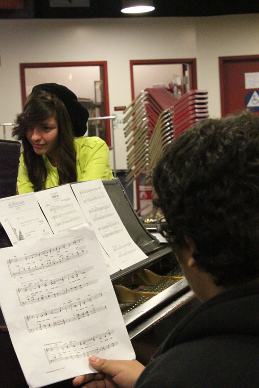 Looking over choral music during Jazz Choir Seniors Jonny Arenas and Angelica Villarreal practice their parts by the piano. Both Arenas and Villarreal auditioned and were accepted into the All-State Jazz Choir, one of the highest high school groups in music.