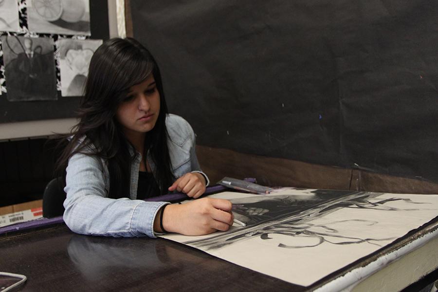 In room Y-2, Adrianna Casas, 12 , shows her appreciation for art while working on her new piece for AP Studio Art, on Monday, October 22. “My inspirations came from my older brother and my grandma,” Casas said, “I guess music inspired me as well.”