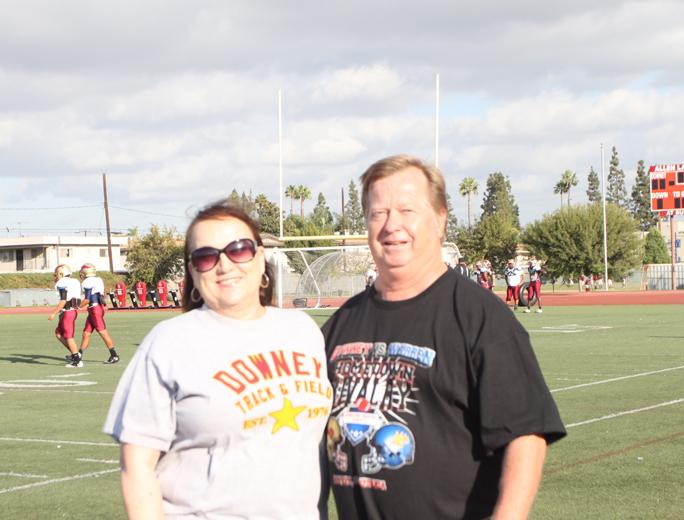 Mr. and Mrs. Gunderson stand on the field in front of the football team as they practice after school on October 22, 2012, in preparation for the homecoming game. Mr. Gunderson attends all home games and nearly every away game.