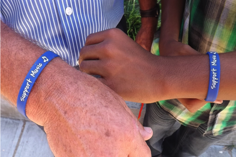The principal of Griffiths Middle School, Mr Stapp, and current drummer for the school’s band, Julian Thomas, 8, show off their “Support Music” wristbands for an ongoing cause. Over the summer the instruments were stolen, so the music department immediately came to action by selling wristbands for $5 each, as a way to fundraise in order to purchase new equipment.