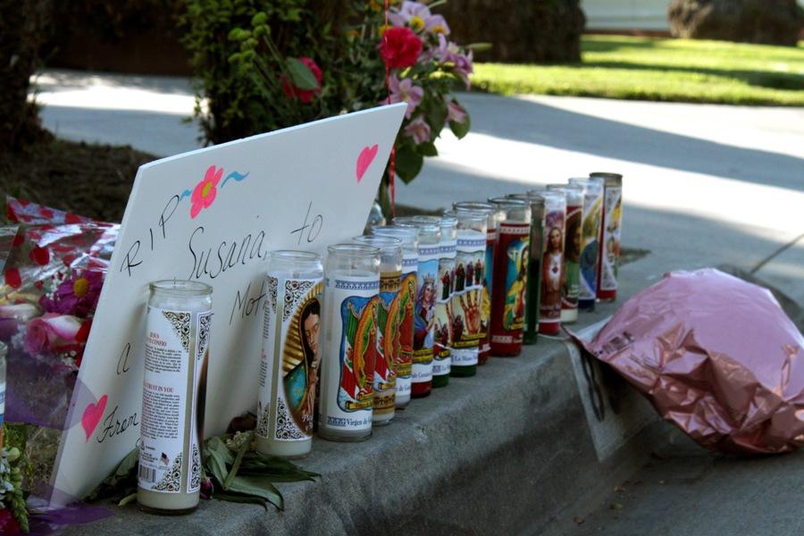 Candles, flowers and a poster are placed in front of the Cleta St. residence to pay tribute to Susana Perez, the mother who was killed, on Wednesday, Oct. 24. Suspect Jade Douglas is currently being held in suspicion of the crime.   