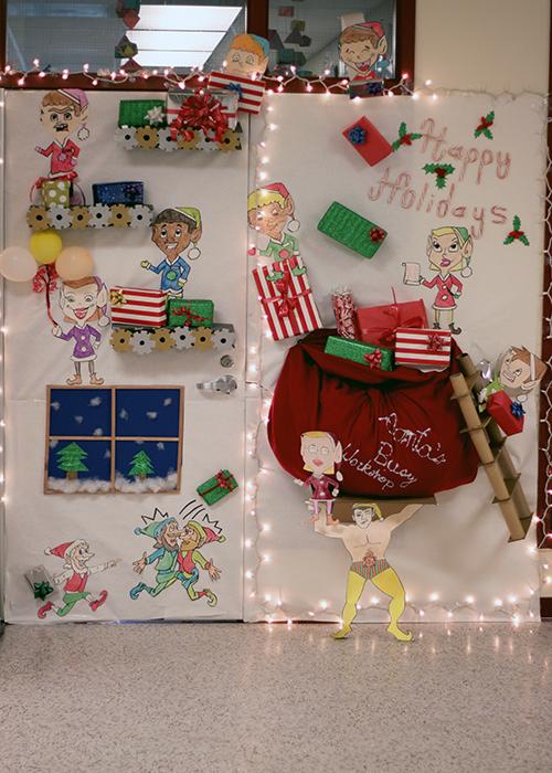 Classes show their holiday spirit by decorating classroom doors for The Door Decorating Contest from December 10 to December 14. Ms. Barabeu, in room C-110, went to the next level with the help of her fourth period class when they each sketched out the design and won second place, leaving Ms. Romero in first. 