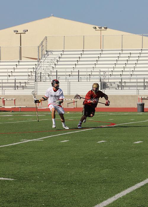 At the varsity lacrosse game vs. Palos Verdes on March 4, captain Nick Farina, 12, defends the ball from the opponent, making a goal. “Over forty different colleges have scouted me this year,” Farina said. “I have decided to go to Adam State in Alamosa, Colorado.”