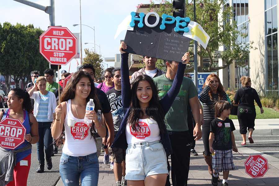 On Oct. 13, Elle Neri, 11, and, Brenda Alvizures, 11, marches down Firestone Blvd. to support the annual CROP Hunger Walk event. “I felt united as a community,” Alvizures, “getting together trying to make a difference in someone’s life.”