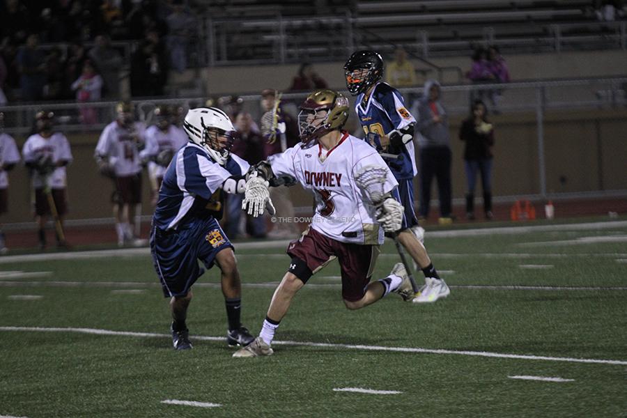 At Downey High School on Fri., Mar. 7, varsity lacrosse player Nicholas Silva, 12, plays against Birmingham High School to start the season. Downey lost with a score of 8 to 9.