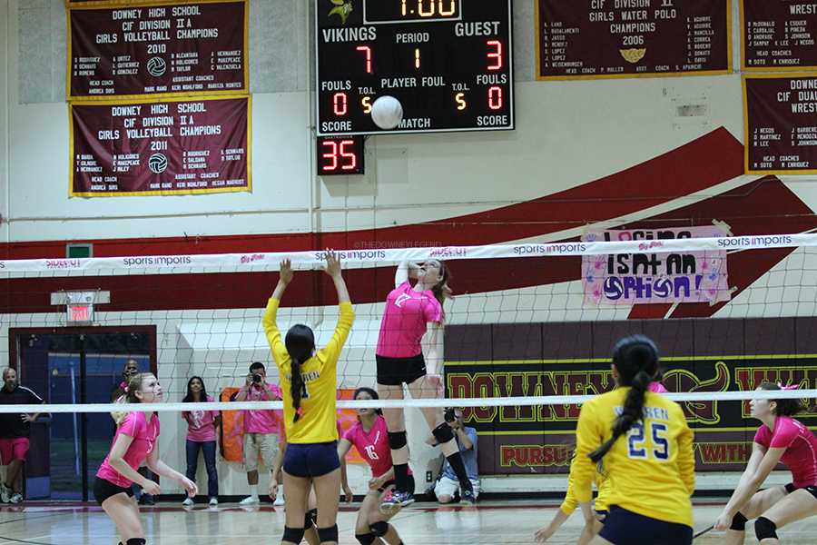 At the annual, Downey vs. Warren, Dig Pink volleyball game, Kimberly Schnars, 12, spikes a serve to intimidate her rivals. Schnars demonstrated her skills with her high jumps and powerful serves.