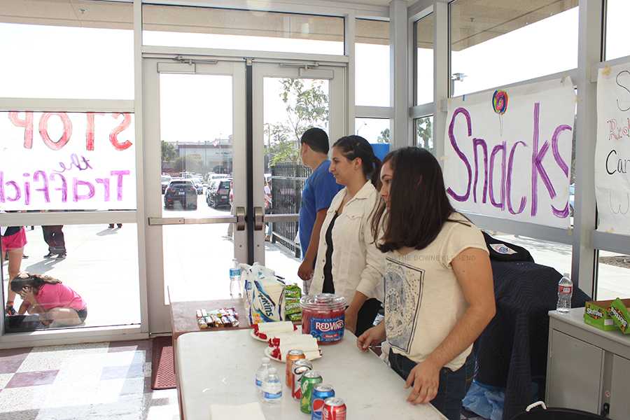 Arriving inside the theater on Thursday, Oct. 23, students sell candy for a dollar to help aid the young girls that are victims of sex trafficking. Club members sold sodas, candy bars, Skittles, and red licorice to help raise enough money to donate to the founders to rescue the young girls.