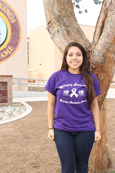 Promoting a walk for epilepsy, on Nov.11, Sophia Loulakis, 12, wears her shirt to encourage awareness of the neurological disorder she’s been battling for five years and now. “I want to make sure everyone is aware, and that it’s not a joke,” Loulakis said.  “Cancer may kill but so does epilepsy.” 