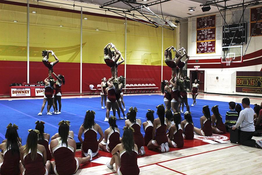 	In the gym on Jan. 19, the varsity cheer team’s flyers practice their scorpions for their competition in Dallas, Texas. “We are not use to this kind of routine; it’s different,” Avrion Gray, 12, said. “There are a lot of things going on.”  
