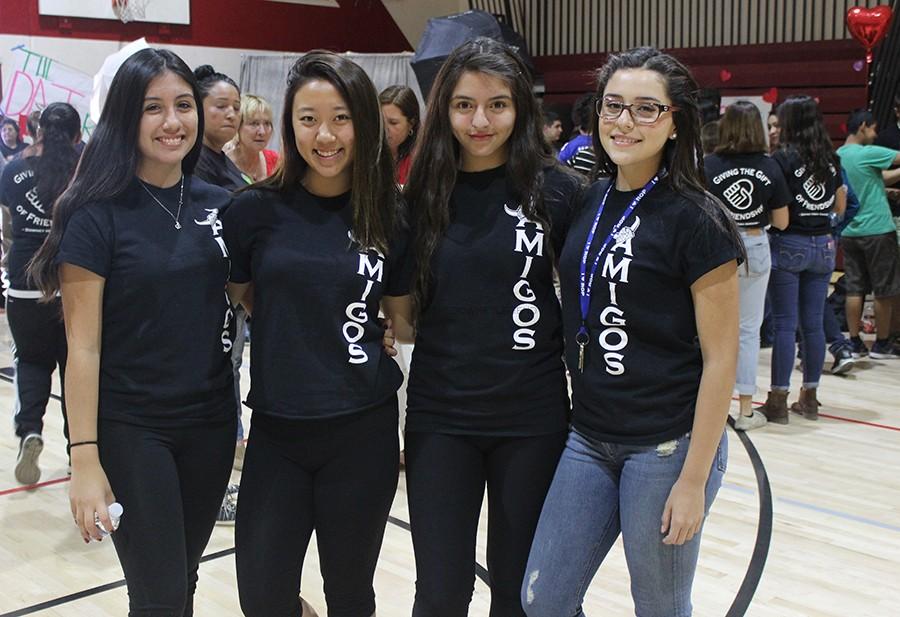 To represent their club, juniors Julissa Trelles, Claire Yoon, Angelina Padilla, and sophomore April Tapia  sport their new t-shirts at the Valentine’s Day dance on Feb. 12. The club’s newly designed shirt has the word AMIGOS went vertically down the front and GIVING THE HOPE OF FRIENDSHIP on the back.