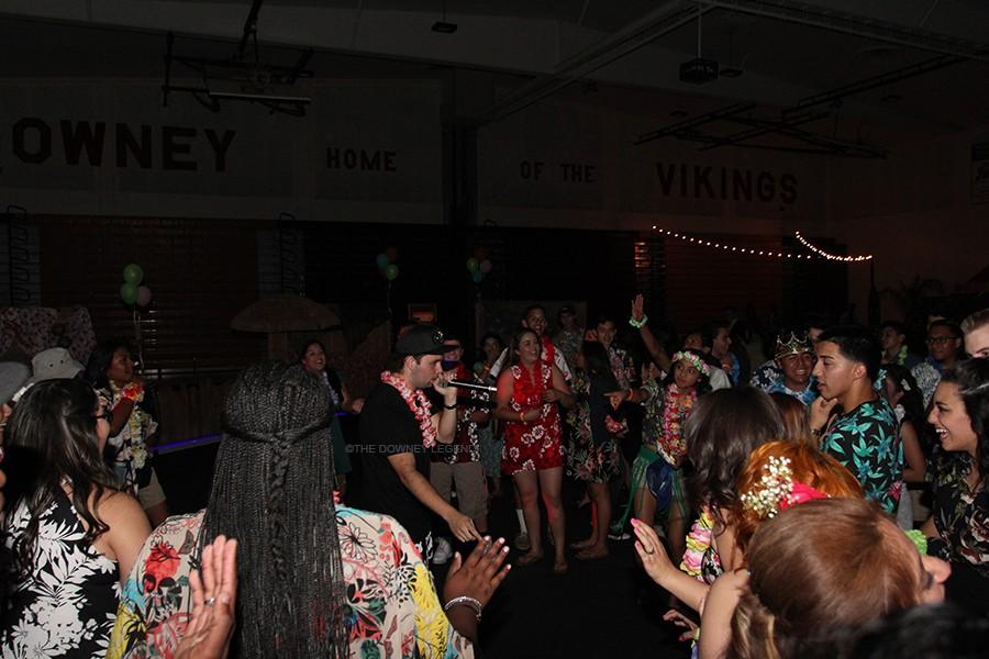 At the Downey High School gym on April 17, the Sadie’s DJ interacts with students attending the dance to get the crowd hyped up. “ The DJ was awesome, [I] love how he came down and hyped us up,” senior Destiny Ayala said. 