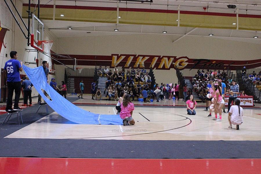 To introduce spring sports and help the Stop the Traffick club, Downey High School hosts a Battle of the Sexes night rally on April 30 to fundraise for sex trafficking awareness.  Dulce Gutierrez, 11, held a beanbag baseball in efforts to score a point for the girls by shooting it through the hole. 