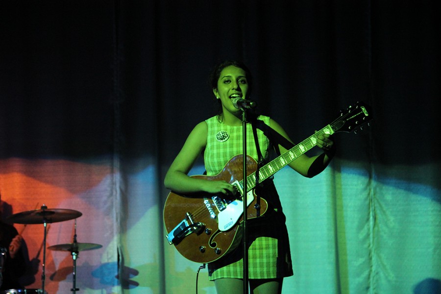 Lead singer of the Doo Rons, Stephanie Castandea, 12, strums her guitar while singing along to the chorus on March 11. The Doo Rons upcoming events can be found on Facebook.