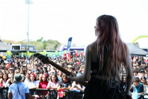 On stage performing with her band, Crimson Apple, bassist Carthi Benson plays for the students of Downey High School at High School Nation’s 2019 Tour on Mar. 31. The Benson sisters grew up in Hawaii and moved to the big city of Los Angeles where they now write, play, and rehearse their music. 