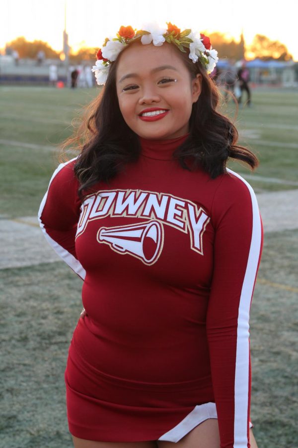 Ready to give it her all during her Downey versus Warren performance, Rachelle Escurel, 10, second year cheerleader, warms up before the big game.  “I personally am very excited,” Escurel said. “I love cheering at football games, especially like in front of the crowd ‘cause it’s different practicing it inside the gym versus in front of others.”  