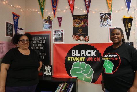 Ms. Wilkenfeld [left] and Mrs. Brumfield [right] pose in front of the school’s official student-designed Black Student Union banner.