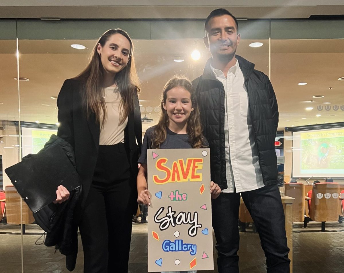 Young speaker stands with Stay Gallery Programs Director Juliana Canty and Executive Director Gabriel Enamorado at the November 14th Downey City Council meeting at City Hall.